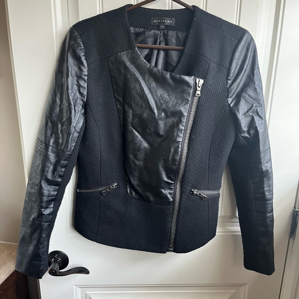 Black jacket with contrasting vegan leather sleeves.